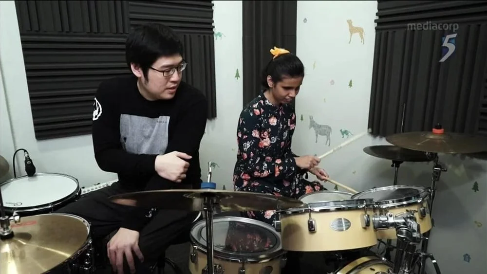 Chua Chun Leng teaching Nurul drums